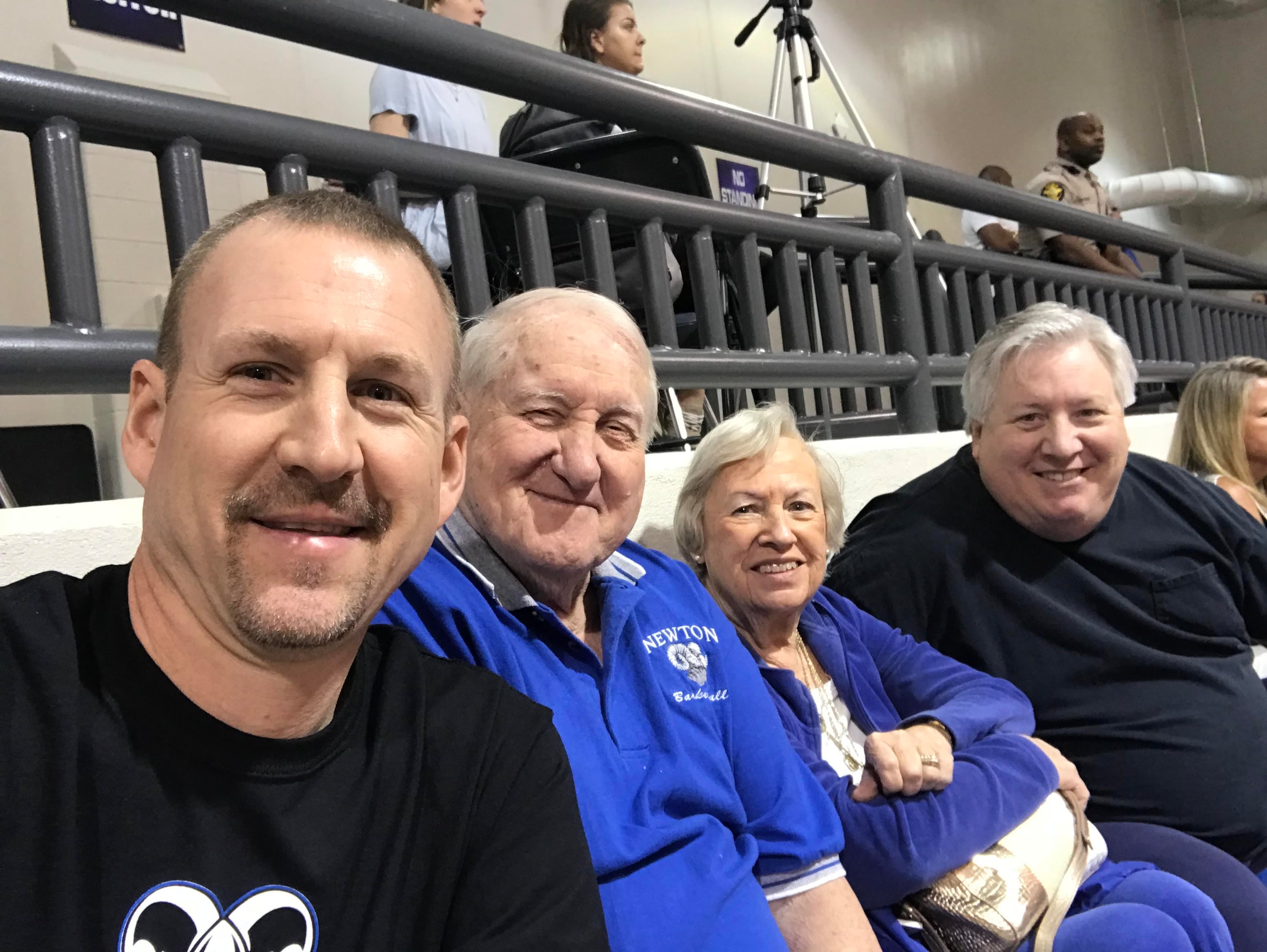 Then-Newton coach Rick Rasmussen (left), Ronald and Jan Bradley (center), son Brad Bradley (right) at a Newton basketball game in 2018. (Photo courtesy Rick Rasmussen)
