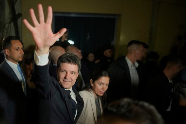 Presidential candidate Nicusor Dan waves to his supporters after polls closed for the second round of the country's presidential election redo in Bucharest, Romania, early Monday, May 19, 2025. (AP Photo/Vadim Ghirda)