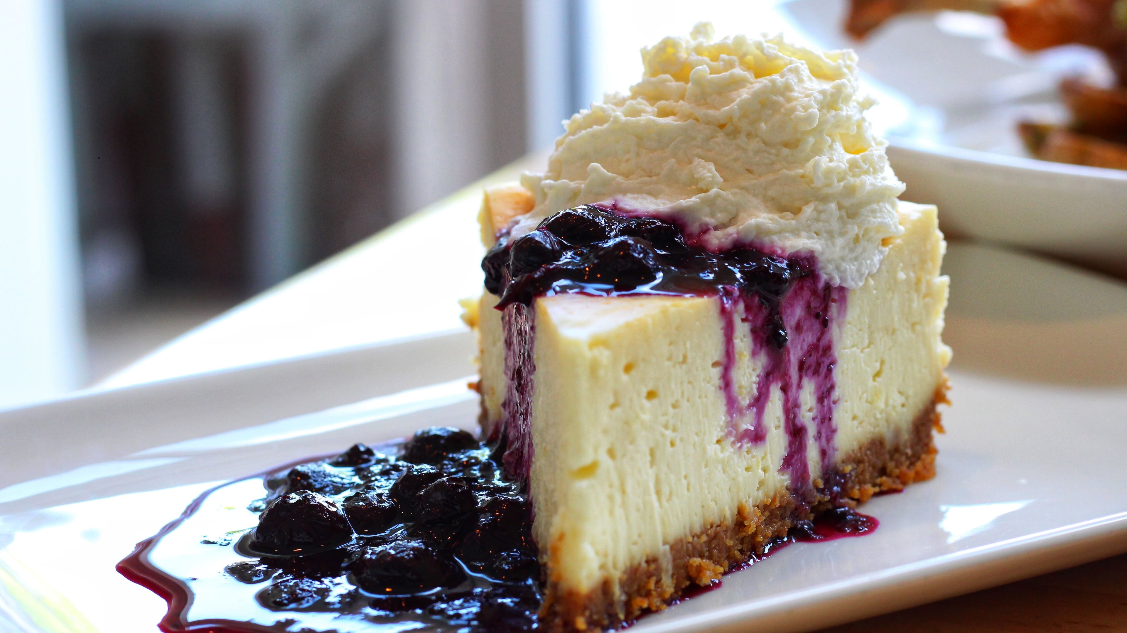 The lemon mascarpone cheesecake on Seed Kitchen & Bar's dessert menu arrives with blueberry compote and whipped cream. (Courtesy of Seed Kitchen & Bar)
