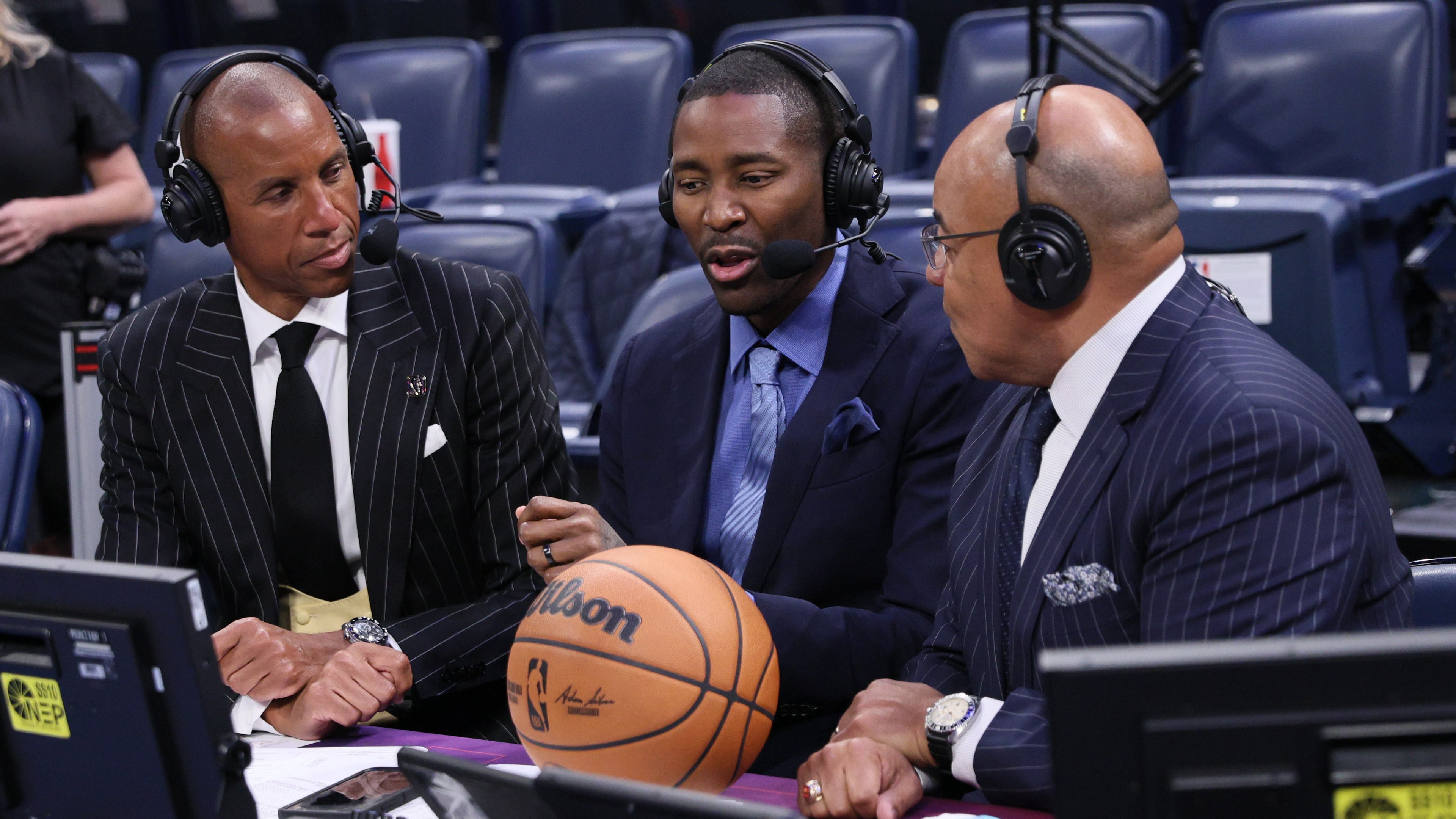 NBC Sports broadcasters, from left, Reggie Miller, Jamal Crawford and Mike Tirico talk after an NBA basketball game between the Houston Rockets and Oklahoma City Thunder, Tuesday, Oct. 21, 2025, in Oklahoma City. (AP Photo/Nate Billings)
