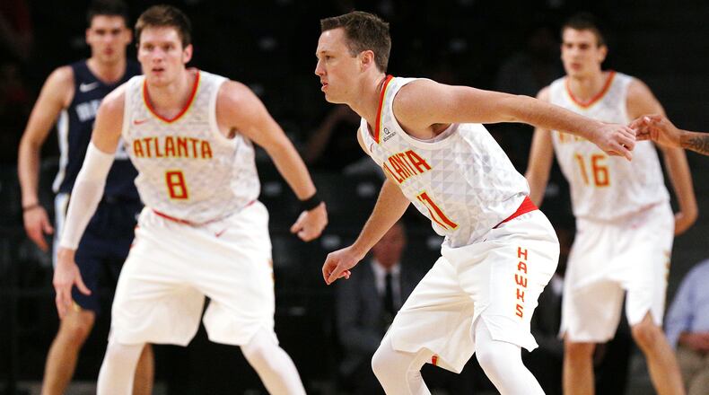 Hawks Luke Babbitt (from left), Josh Magette, and Nicolas Brussino defend against the Grizzlies during the second half in a NBA preseason basketball game on Monday, October 9, 2017, in Atlanta.   Curtis Compton/ccompton@ajc.com