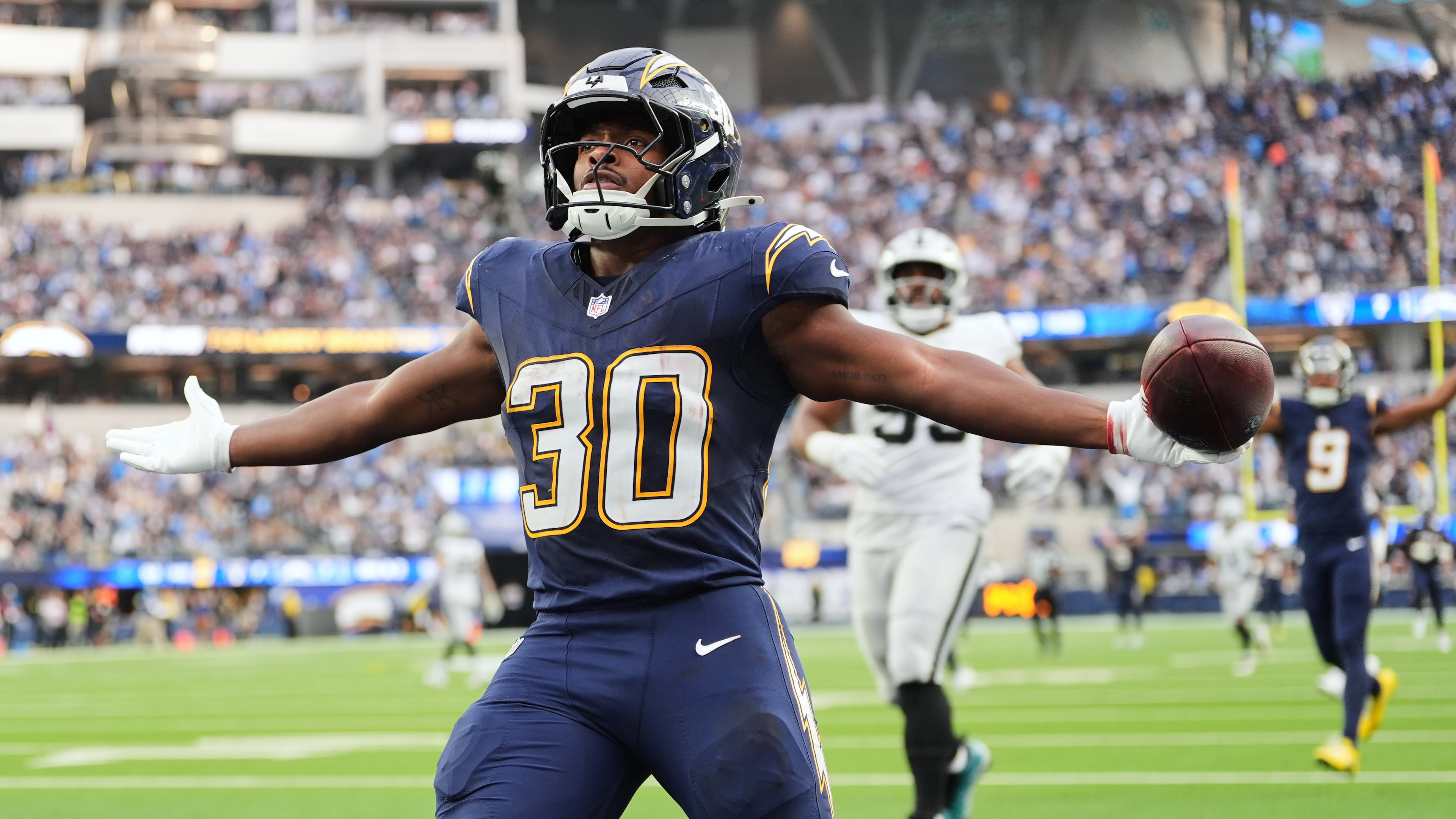 Los Angeles Chargers running back Kimani Vidal (30) celebrates after scoring a touchdown during the second half of an NFL football game against the Las Vegas Raiders, Sunday, Nov. 30, 2025, in Inglewood, Calif. (AP Photo/Jae C. Hong)
