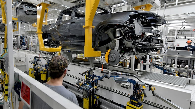 Manufacturing workers assemble the R1T electric vehicle at Rivian in Normal, Ill., on July 20, 2022. (Photo for the Atlanta Journal Constitution by Ron Johnson)