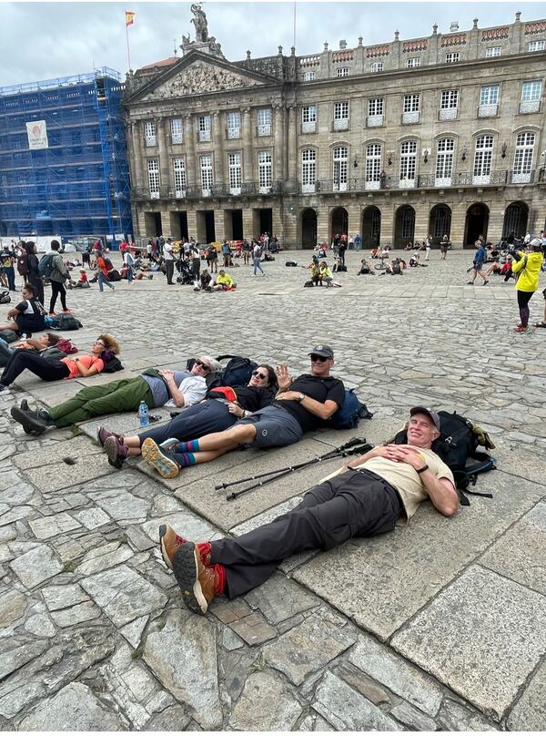 The crew relaxes in the plaza in front of the cathedral after completing a portion of the El Camino de Santiago