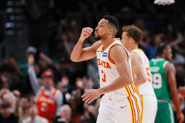Atlanta Hawks guard CJ McCollum celebrates after making a three-point shot against the Boston Celtics in the second half of their game at State Farm Arena on March 30. (Jason Getz/AJC)