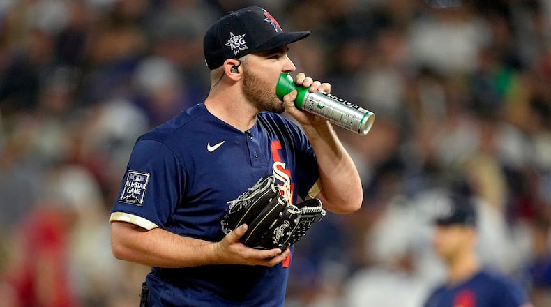 American League's Liam Hendriks, of the Chicago White Sox, right, takes oxygen on the mound during the ninth inning of the MLB All-Star baseball game, Tuesday, July 13, 2021, in Denver. (AP Photo/Jack Dempsey)