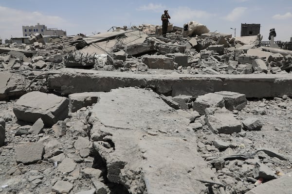 A Yemeni soldier inspects the damage reportedly caused by U.S. airstrikes in Sanaa, Yemen, Sunday, April 27, 2025. (AP Photo/Osamah Abdulrahman)
