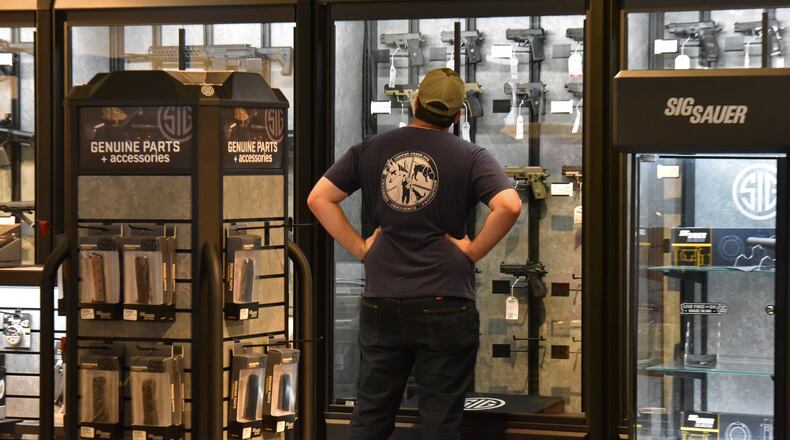 October 5, 2017 Atlanta - A customer looks a wide range of rifles and shotguns at Stoddard's Range and Guns on Thursday, October 5, 2017. HYOSUB SHIN / HSHIN@AJC.COM