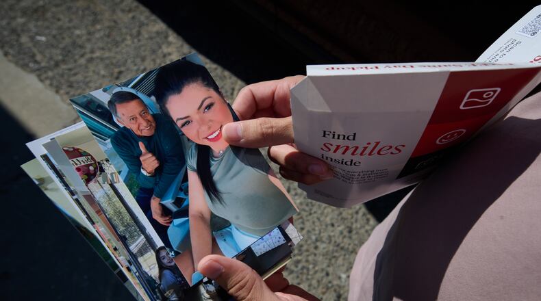 Army Staff Sgt. Alexis Jaramillo shows photos of his wife, Maisa Lopes Eliaser, a Brazilian national who is detained by ICE, near the South Louisiana ICE Processing Center where she is currently held, in Basile, La., Sunday, Aug. 2, 2026. (AP Photo/Joseph Vidrine)