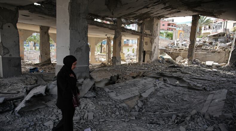A local resident walks among debris inside a mosque destroyed in an Israeli airstrike in Jibchit, southern Lebanon, Friday, April 17, 2026, following a ceasefire between Israel and Hezbollah. (AP Photo/Hassan Ammar)