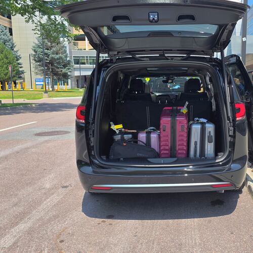 Luggage fills the cargo area of a 2027 Chrysler Pacifica at Burlington International Airport in Vermont before Chris Hardesty's family road trip home to Georgia. (Chris Hardesty/Cox Automotive)