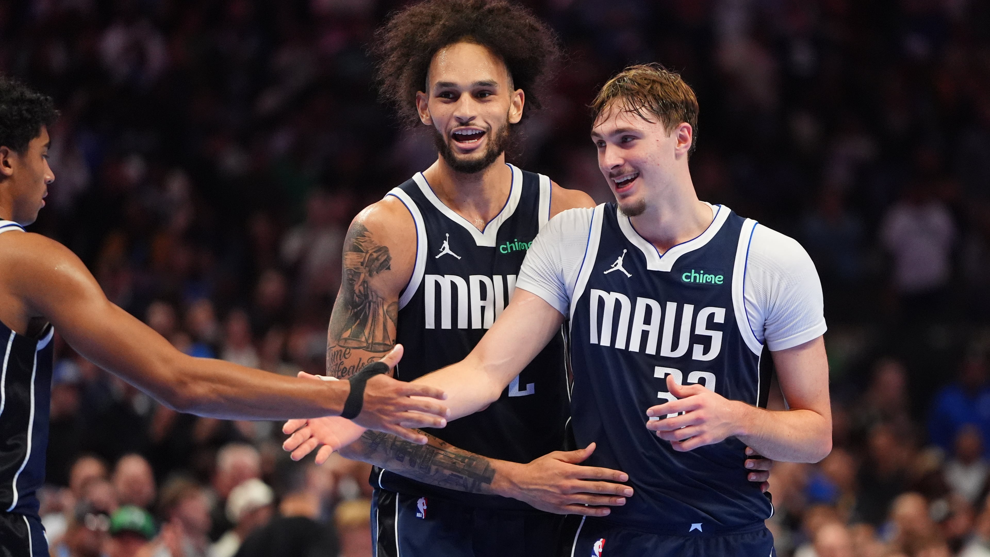 CORRECT PLAYER AT CENTER - Dallas Mavericks forward Cooper Flagg (32) celebrates with teammates guard Max Christie, left, and center Dereck Lively II (2) during the second half of an NBA basketball game against the New Orleans Pelicans in Dallas, Friday, Nov. 21, 2025. (AP Photo/LM Otero)