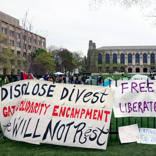 FILE - Signs are displayed outside a tent encampment at Northwestern University on April 26, 2024, in Evanston, Illinois. (AP Photo/Teresa Crawford, file)