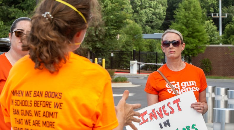Outside the Cobb County school board's meeting, parents and advocates, including Katie Kroll, gather to voice concerns for safety at schools and accountability for finances on Thursday, June 9, 2022. (Jenni Girtman for The Atlanta Journal-Constitution)