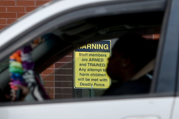 03/25/19 - Dublin -  Shamecca Plummer, a parent of students who attend East Laurens Middle-High School, waits on Monday in her car for her kids to get out of school. The school has posted signs to let visitors know staff members are carrying weapons. Plummer says she doesn't think firearms have any place in schools. "I don't think it's good because you never know. A kid might could still find a weapon and use it on the teacher or whoever," she says. "It's really dangerous to have it on campus anyway." Jenna Eason for The Atlanta-Journal Constitution.