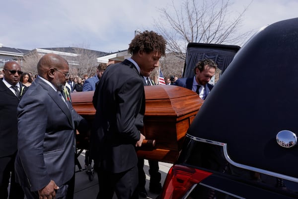 Peyton Love, front right, and Jason Love, behind right, place the casket of their mother and wife, former U.S. Rep. Mia Love, into a hearse after her memorial service at The Church of Jesus Christ of Latter-day Saints on the University of Utah campus in Salt Lake City, Monday, April 7, 2025. (AP Photo/Melissa Majchrzak)