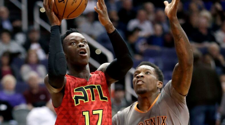 Atlanta Hawks guard Dennis Schroder (17) shoots over Phoenix Suns guard Eric Bledsoe (2) during the first half of an NBA basketball game, Wednesday, Nov. 30, 2016, in Phoenix. (AP Photo/Matt York)