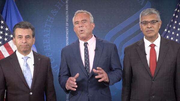 This image from video shows Dr. Martin Makary (from left), Health and Human Services Secretary Robert F. Kennedy Jr. and Dr. Jay Bhattacharya as Kennedy announces that the Centers for Disease Control and Prevention list will no longer recommend the COVID-19 vaccine for healthy children or pregnant women. (Health and Human Services via AP)