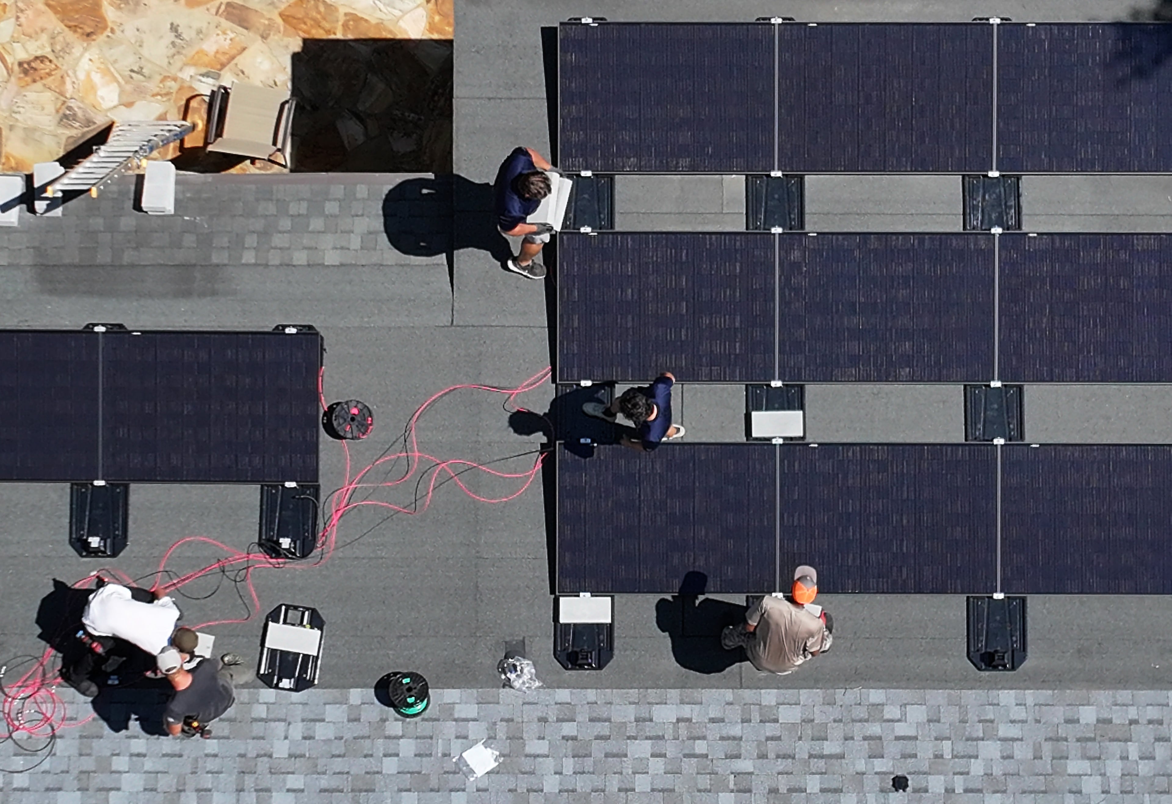Workers with Custom Solar Solutions install solar panels on the roof of the Adler family home, Thursday, July 17, 2025, in Atlanta's North Druid Hills neighborhood. (Hyosub Shin/AJC)