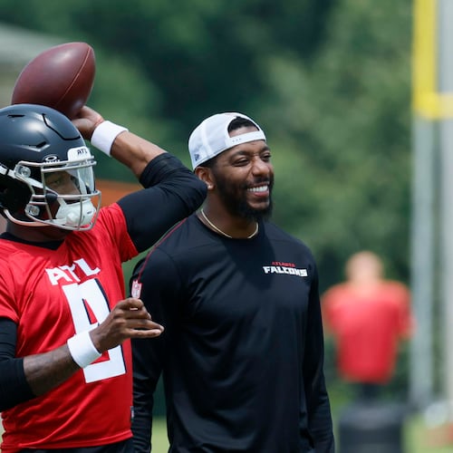Atlanta Falcons quarterback Michael Penix Jr (left) attempts a pass alongside quarterbacks coach D.J. Williams (right) at the Atlanta Falcons Training Facility, Monday, June 2, 2025, in Flowery Branch, Ga. (Miguel Martinez/AJC)