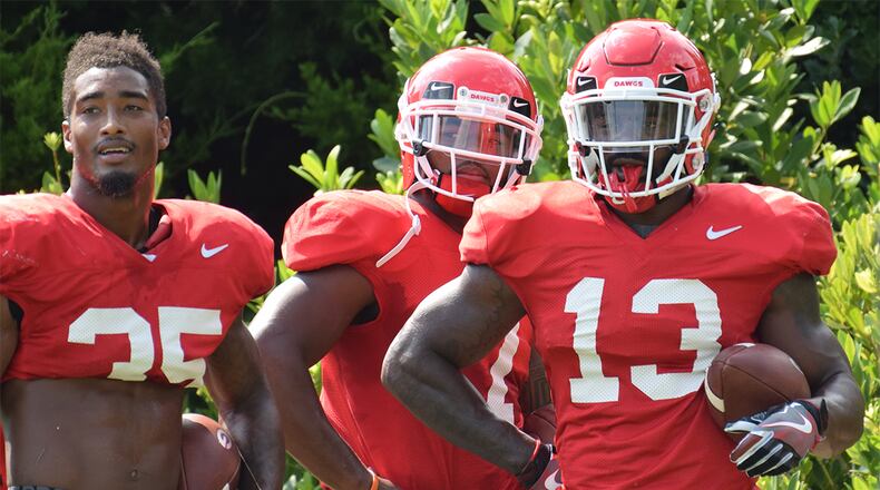 Georgia tailbacks Brian Herrien (35), D'Andre Swift (7) and Elijah Holyfield (13) during the Bulldogs' practice Tuesday, Aug. 21, 2018, on the Woodruff Practice Fields in Athens.