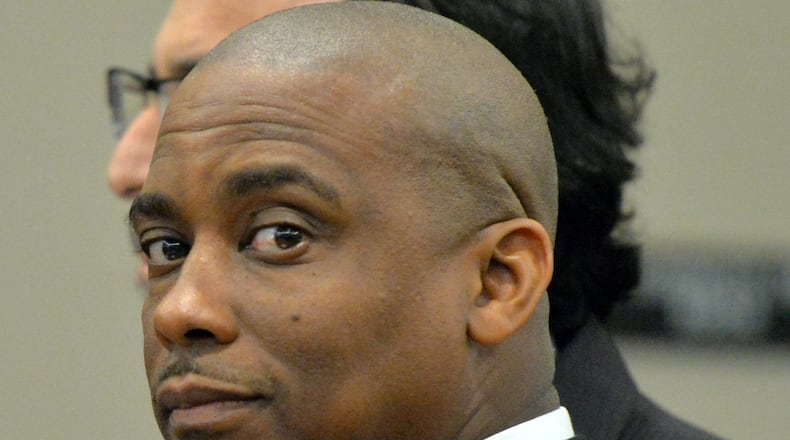 Aug. 15, 2013: Clayton County Sheriff Victor Hill, with his defense attorney Drew Findling (background, holding Hill’s shoulder), just before the jury cleared Hill of all counts in a racketeering trial. HYOSUB SHIN / HSHIN@AJC.COM