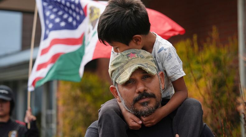 FILE - Gerardo Santos lifts his son Xavier, 5, on his shoulders during a protest in reaction to immigration raids, July 11, 2025, in Oxnard, Calif. (AP Photo/Jae C. Hong, File)