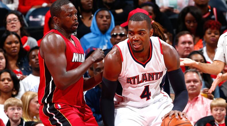 The Hawks’ Paul Millsap drives against the Heat’s Luol Deng during a game earlier this season. (Photo by Kevin C. Cox/Getty Images)