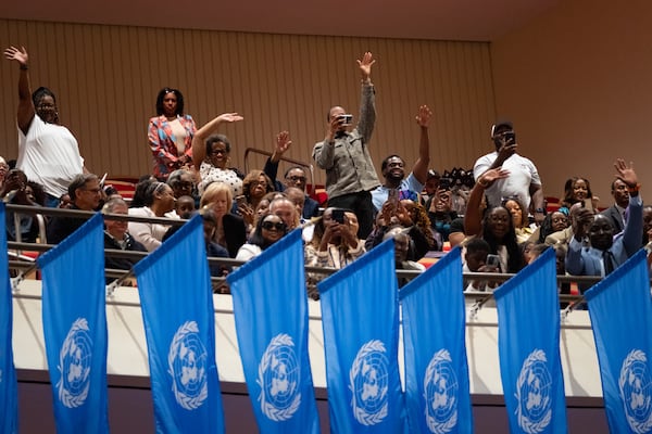 Family members cheer and try to draw the attention of their students at the beginning of the graduation ceremony for Morehouse School of Medicine in Atlanta on Saturday, May 16, 2026. (Ben Gray for the AJC)