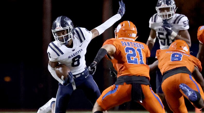 Marietta wide receiver Zuri Johnson (8) makes a move after a catch in the first half of Friday's game against Parkview.