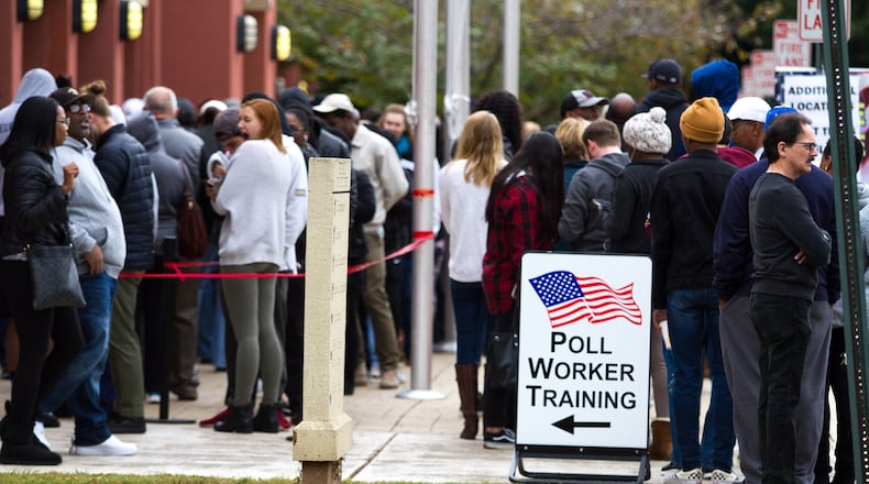 People wait in a long line to vote Saturday at the Cobb County Board of Elections and Registration office in Marietta, GA October 27, 2018. STEVE SCHAEFER / SPECIAL TO THE AJC