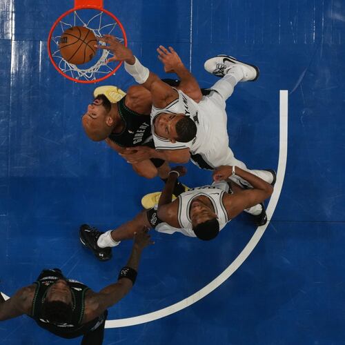 San Antonio Spurs forward Victor Wembanyama (1), right, scores against Minnesota Timberwolves center Rudy Gobert (27) during the first half of Game 4 of an NBA basketball second-round playoffs series, Sunday, May 10, 2026, in Minneapolis. (AP Photo/Abbie Parr)