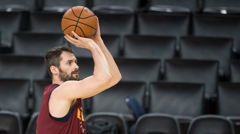 Kevin Love shoots the basketball during NBA Finals media day at Oracle Arena.
