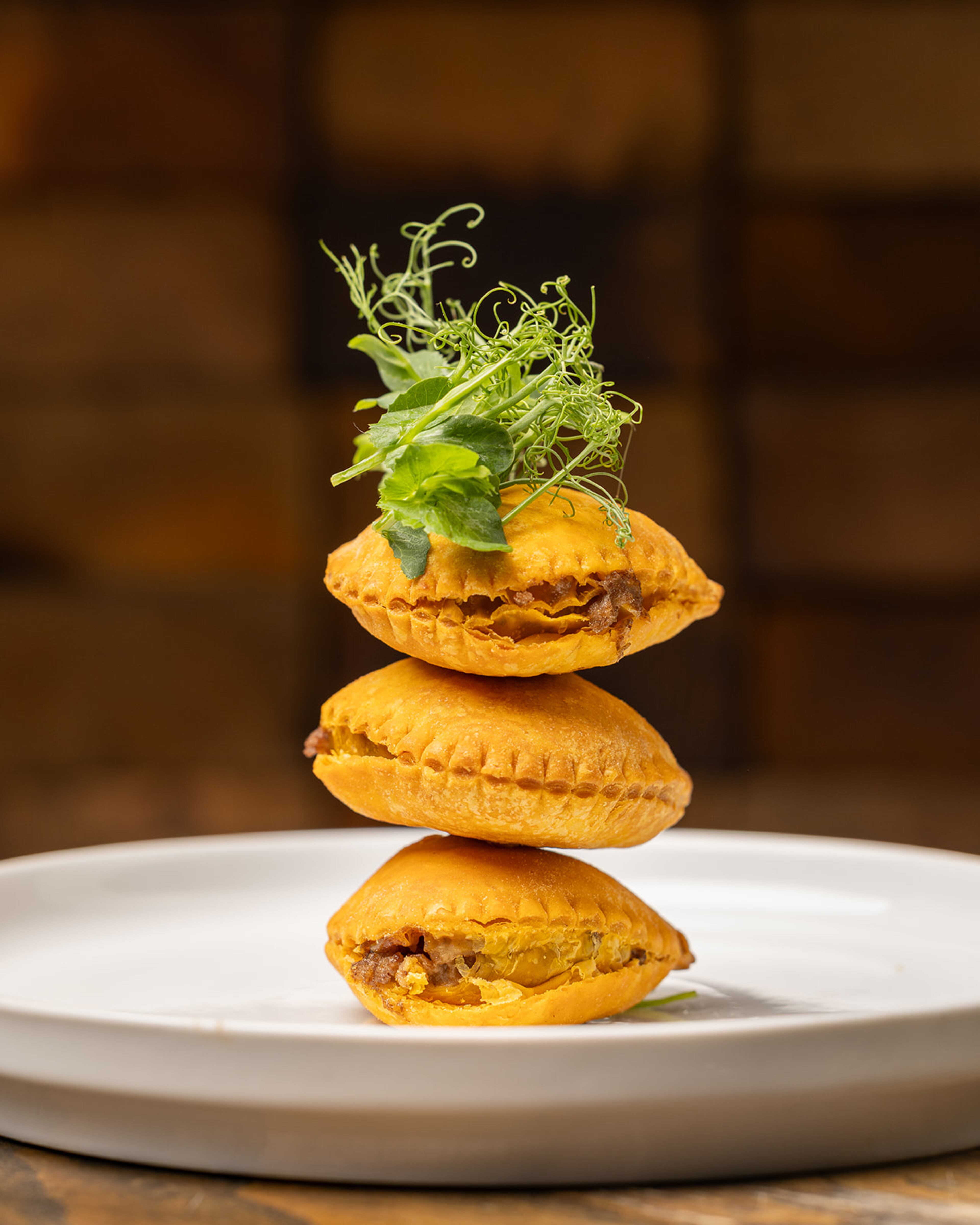 The crust of the oxtail empanadas at Peckish are tender and flaky yet sturdy enough to corral its hearty filling. (Courtesy of Atlanta Creative Media)