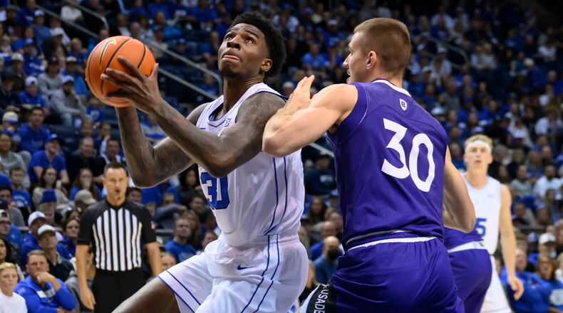 BYU forward Kennard Davis Jr. drives to the basket guarded by Holy Cross guard Joe Nugent (30) during the first half of an NCAA college basketball game, Saturday, Nov. 8, 2025, in Provo, Utah. (AP Photo/Tyler Tate)