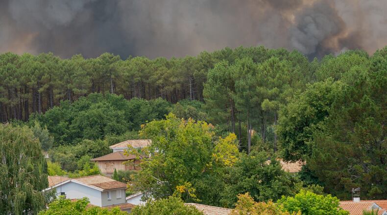 Smoke rises over wildfires in the Lège-Cap-Ferret region, western France, Thursday, July 23, 2026. (AP Photo/Caroline Blumberg)