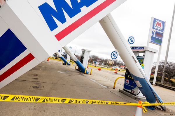 A canopy toppled by severe weather sits outside the Marathon gas station along West Main Street near U.S. 131 in Kalamazoo Twp., Mich., Monday, March 31, 2025. (Joel Bissell/Kalamazoo Gazette via AP)