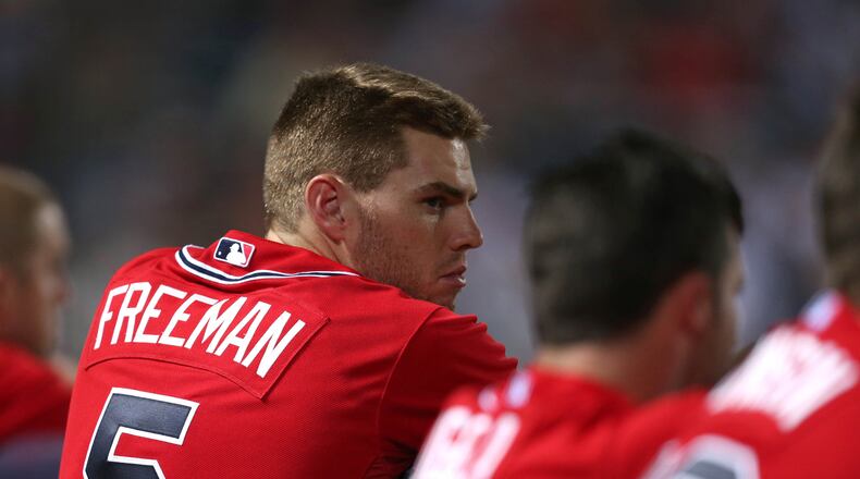 Atlanta Braves first baseman Freddie Freeman leans on the dugout fence with teammates during their game against the Cincinnati Reds at Turner Field Friday night in Atlanta, Ga., July 12, 2013. Freeman was fresh off earning a spot in the All-Star game following Thursday's final voting. This is the second of a four game series versus the Cincinnati Reds.