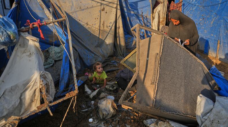 A Palestinian woman inspects the scene of an Israeli airstrike near al-Aqsa Hospital in Deir al-Balah in the central Gaza Strip, Saturday, Aug. 1, 2026. (AP Photo/Abdel Kareem Hana)