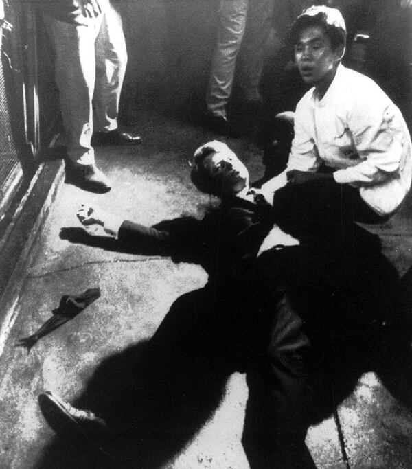 In this June 5, 1968 file photo, Juan Romero, right, comes to the aid of Sen. Robert F. Kennedy as he lies on the floor of the Ambassador Hotel in Los Angeles, moments after he was shot. Romero, who was a 17-year-old busboy, was shaking the senator's hand when gunfire broke out. He held the mortally wounded Kennedy as he lay on the ground, struggling to keep the senator's bleeding head from hitting the floor. Romero died Oct. 1, 2018, at the age of 68. 