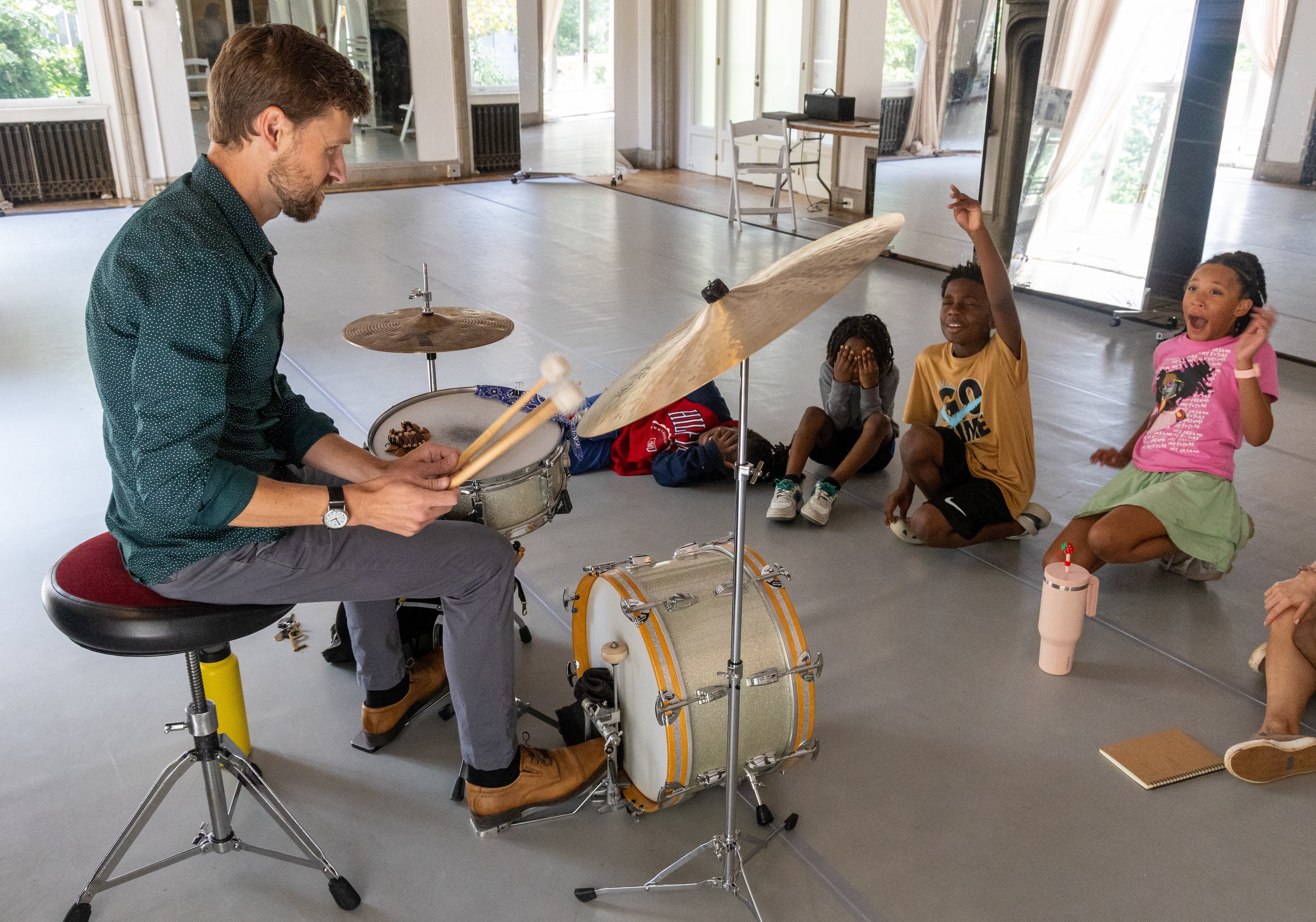 Kids react to the sound as jazz musician & KSU professor Justin Chesarek plays the cymbal at a Callanwolde Fine Arts Center summer camp. (Phil Skinner for The Atlanta Journal-Constitution)