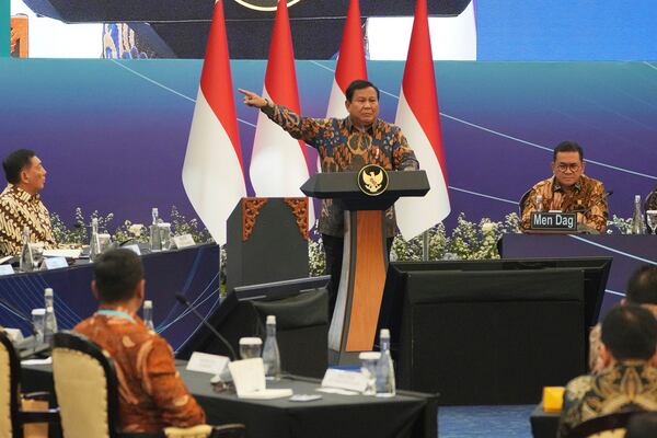 Indonesian President Prabowo Subianto, center, gestures as he delivers a speech during an event called Economic Gathering with the President of the Republic of Indonesia, in Jakarta, Indonesia, Tuesday, April 8, 2025. (AP Photo/Dita Alangkara)