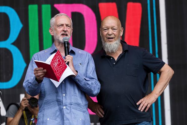 FILE - Britain's Labour Party leader Jeremy Corbyn, left, and organizer Michael Eavis appear onstage at the Glastonbury Festival at Worthy Farm, in Somerset, England, June 24, 2017. (Photo by Grant Pollard/Invision/AP, file)