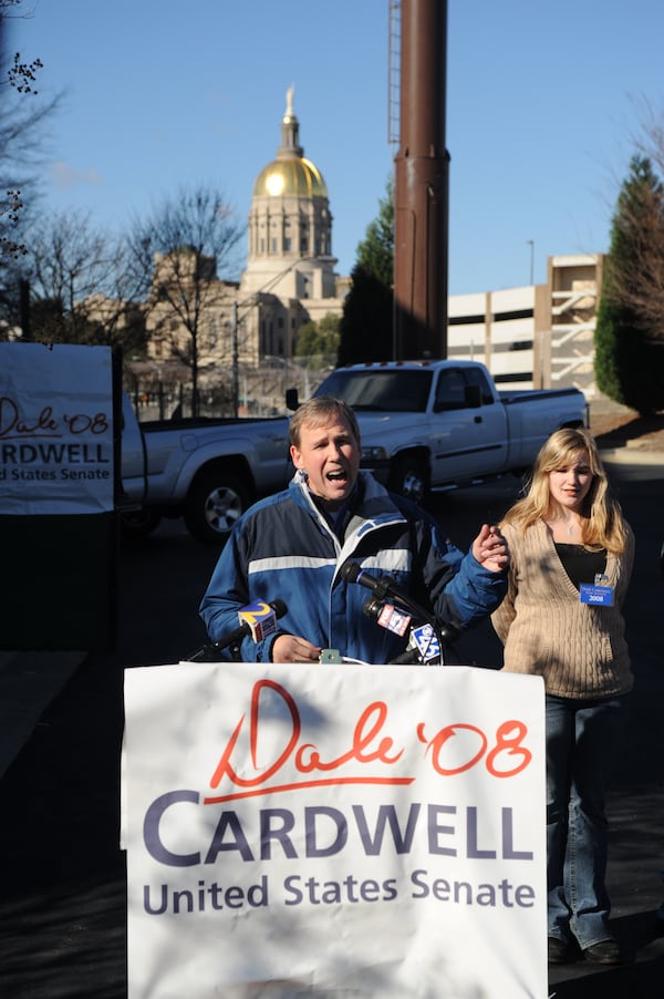 Dale Cardwell, former television journalist, speaks before being raised on an outdoor platform to the top of the Corey Tower in downtown Atlanta on Tuesday, Jan. 1, 2008. On his left is his daughter Jessica. (Stanley Leary/AP)