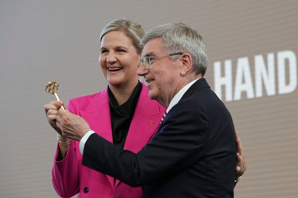 IOC President Thomas Bach, right, and President-elect Kirsty Coventry pose during the handover ceremony of the IOC Presidency at Olympic House in Lausanne, Switzerland, Monday, June 23, 2025. (AP Photo/Laurent Cipriani)