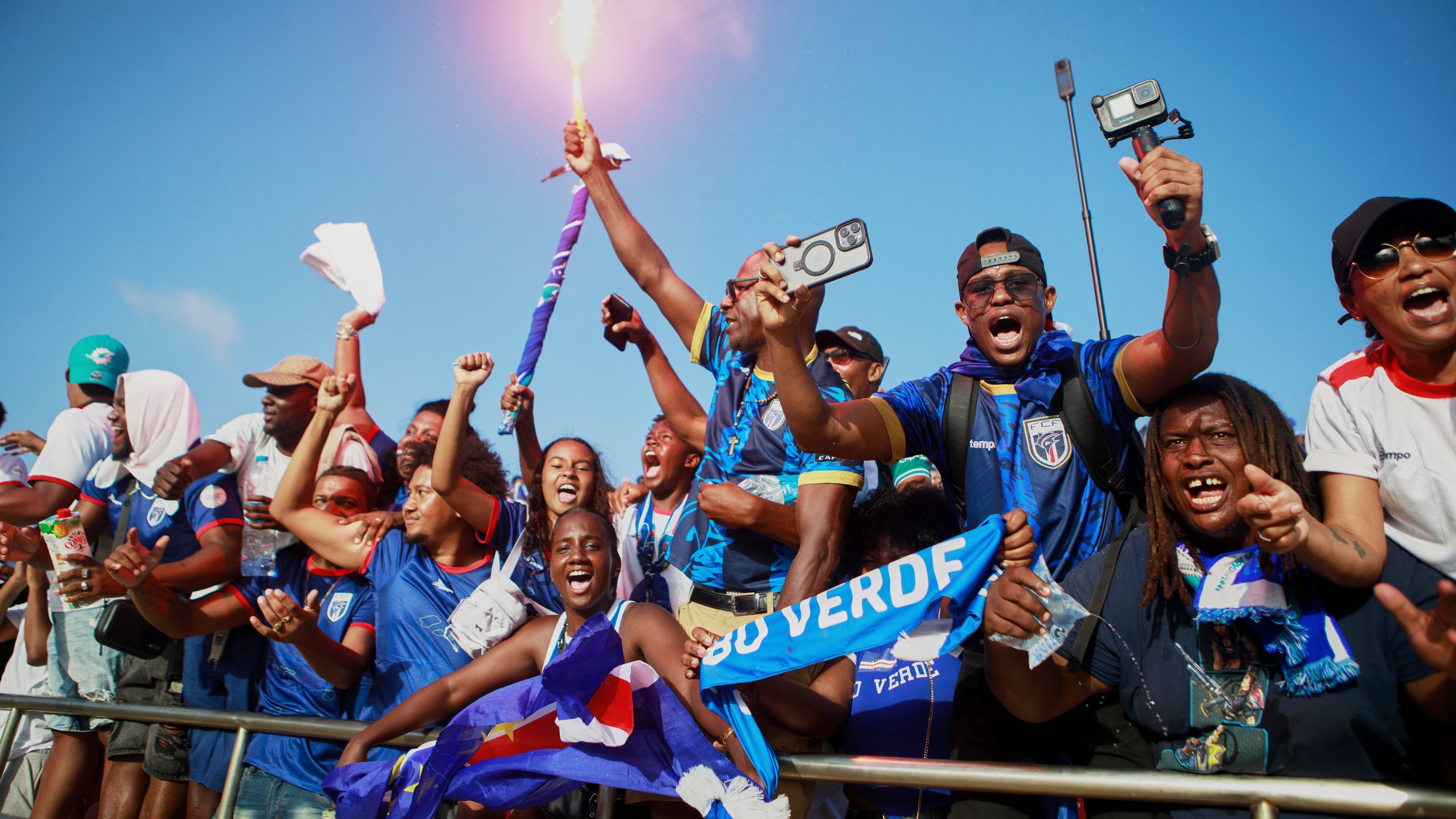 Fans celebrate in the stands after Cape Verde defeated Eswatini in a World Cup qualifying soccer match at Estádio Nacional in Praia, Cape Verde, Monday, Oct. 13, 2025, to clinch their qualification for the 2026 World Cup. (AP Photo/Cristiano Barbosa)