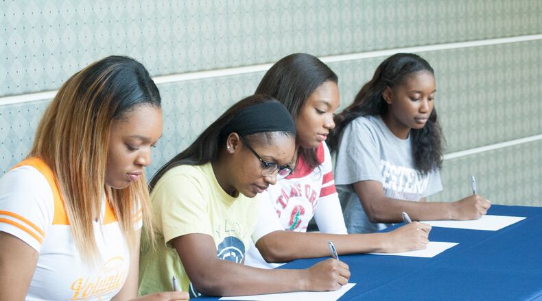 Kasiyahna Kushkituah (left), Taja Cummings, Maya Dodson and Nichel Tampa get ready to sign their national letters of intent. (Amber DeSantis/St. Francis High School)
