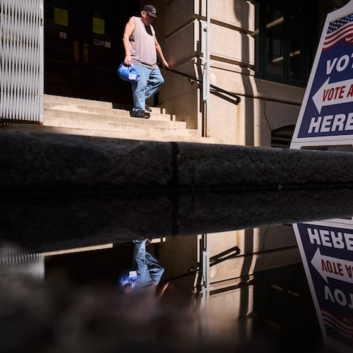 A sign directs voters to an entrance for City Hall during early voting for the Rhode Island primary election, Wednesday, Sept. 2, 2026, in Providence, R.I. (AP Photo/David Goldman)