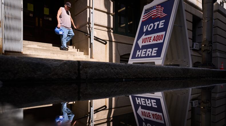 A sign directs voters to an entrance for City Hall during early voting for the Rhode Island primary election, Wednesday, Sept. 2, 2026, in Providence, R.I. (AP Photo/David Goldman)
