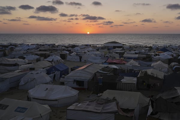 A tent camp for displaced Palestinians stretches near the shore during the sunset in Khan Younis, Gaza Strip, Wednesday, July 2, 2025. (AP Photo/Abdel Kareem Hana)